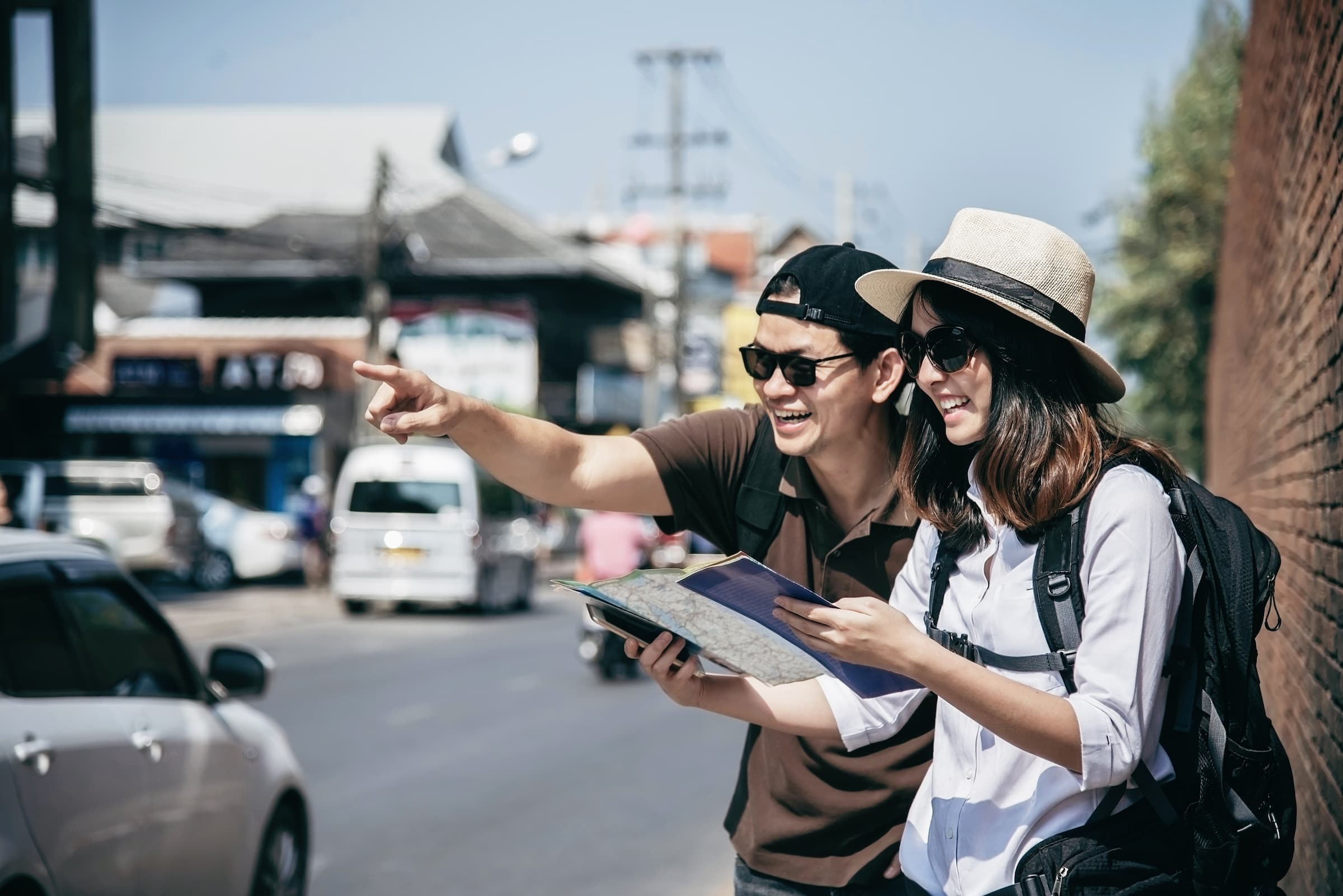 asian-couple-tourist-holding-city-map